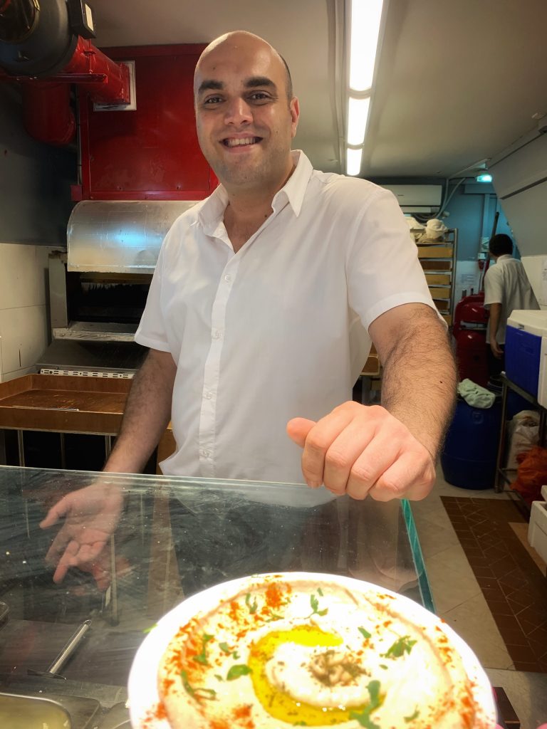 Yuri, part owner of the Pita Bakery in Singapore poses during my Kampong Glam Tour with the bitemojo app - image taken with an iPhone XS