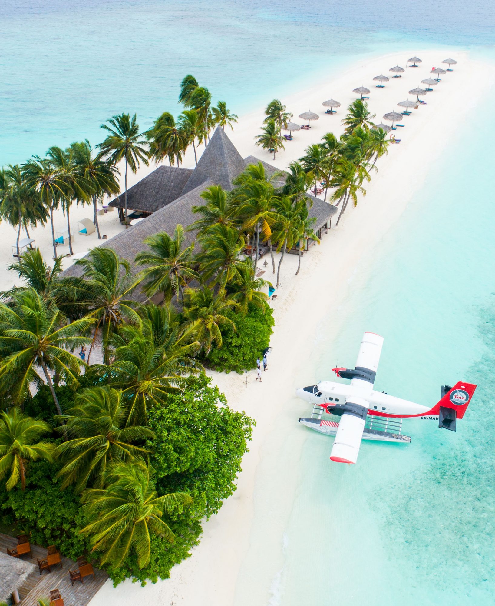 Aerial view of a seaplane parked at a resort on a Maldives island on SelfishMe Travel LLC