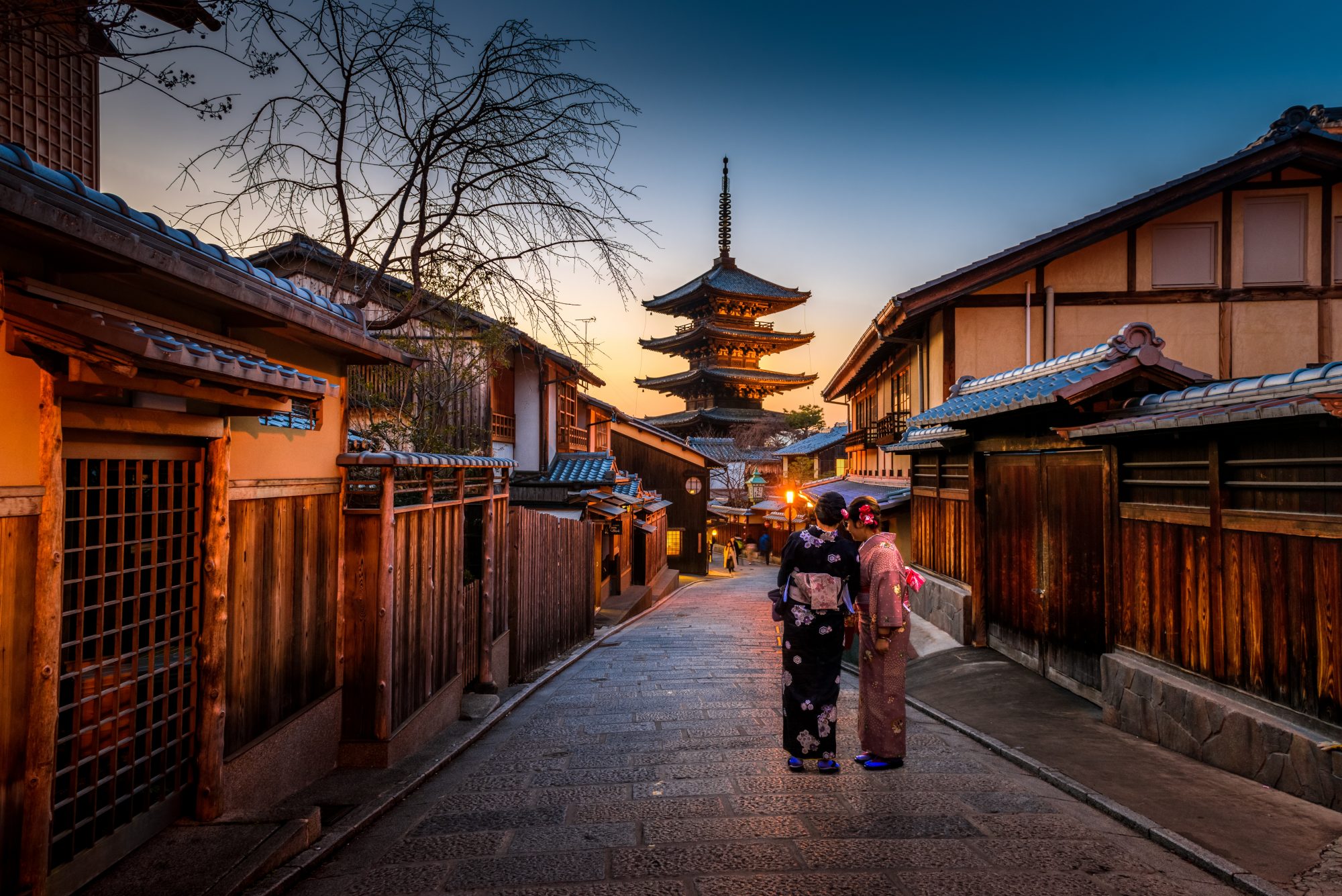 Two women wearing Kimonos in Kyoto Japan at dusk on SelfishMe Travel LLC