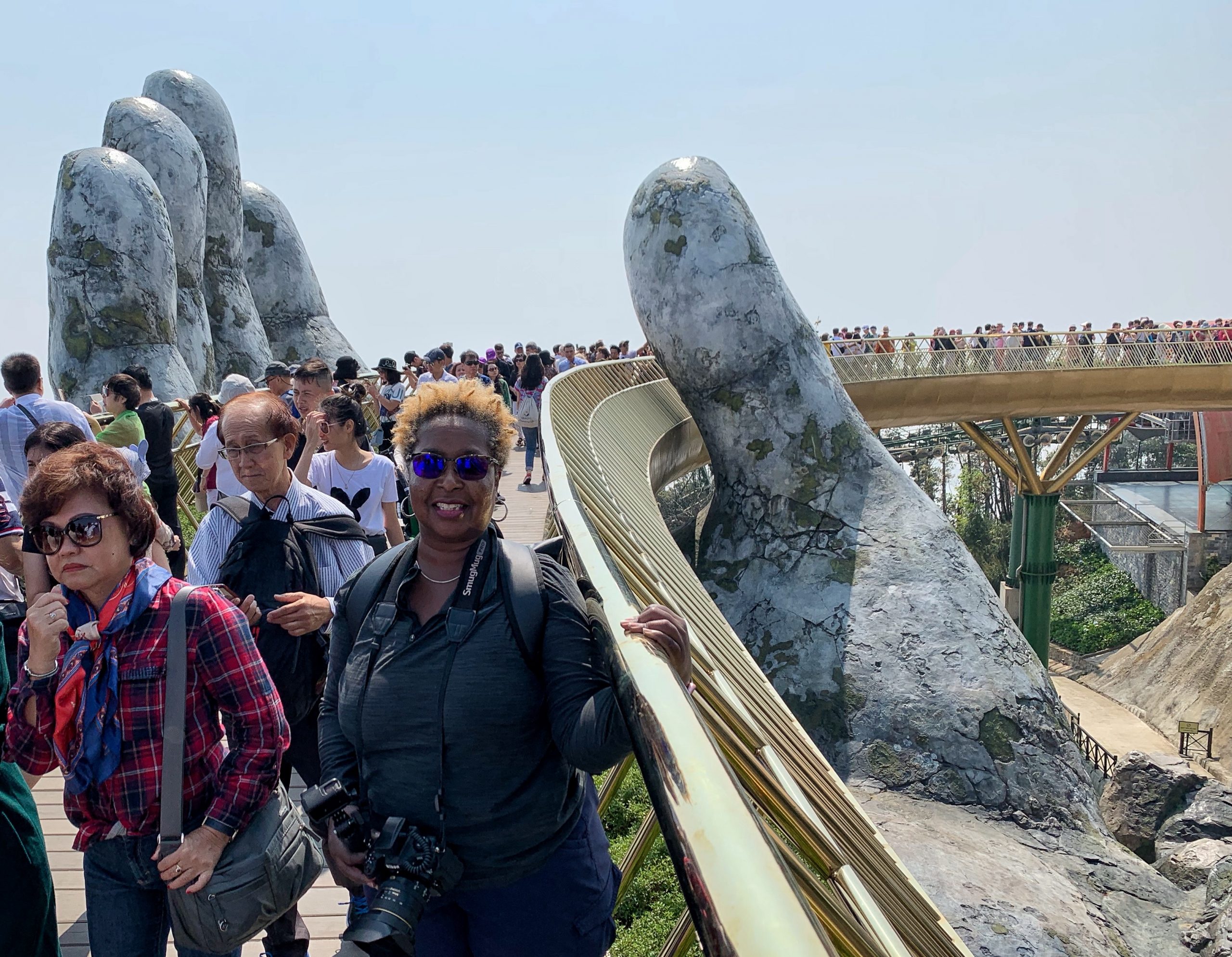 Danielle Lewis, owner of SelfishMe Travel LLC, on the "Hands of God" Golden Bridge at Sunworld's Ba Na Hills in Vietnam - image taken with an iPhone XS